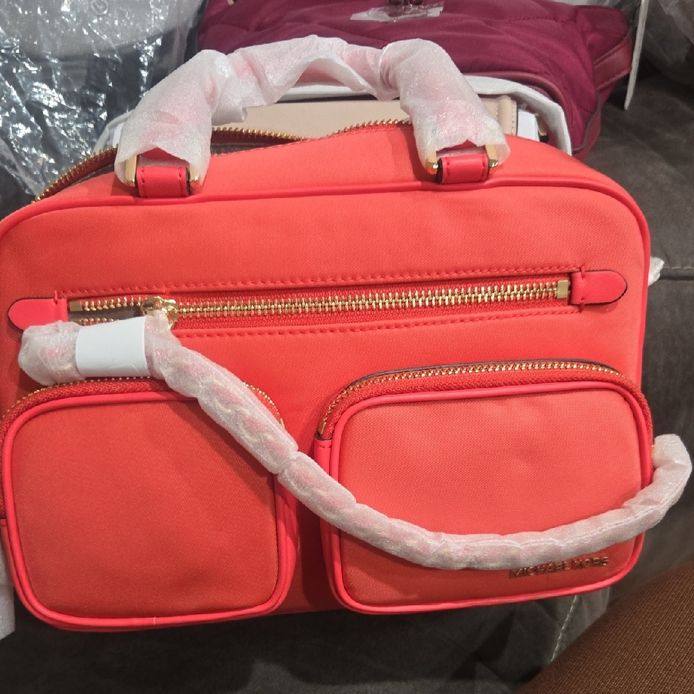 Michael Kors Elliot Vibrant Coral Travel Bag with Gold Accents